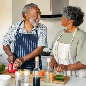 happy-couple-preparing-meal-together